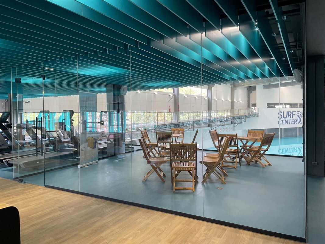 Espaço de coworking do Surf Center Curitiba com vista para a piscina de surf